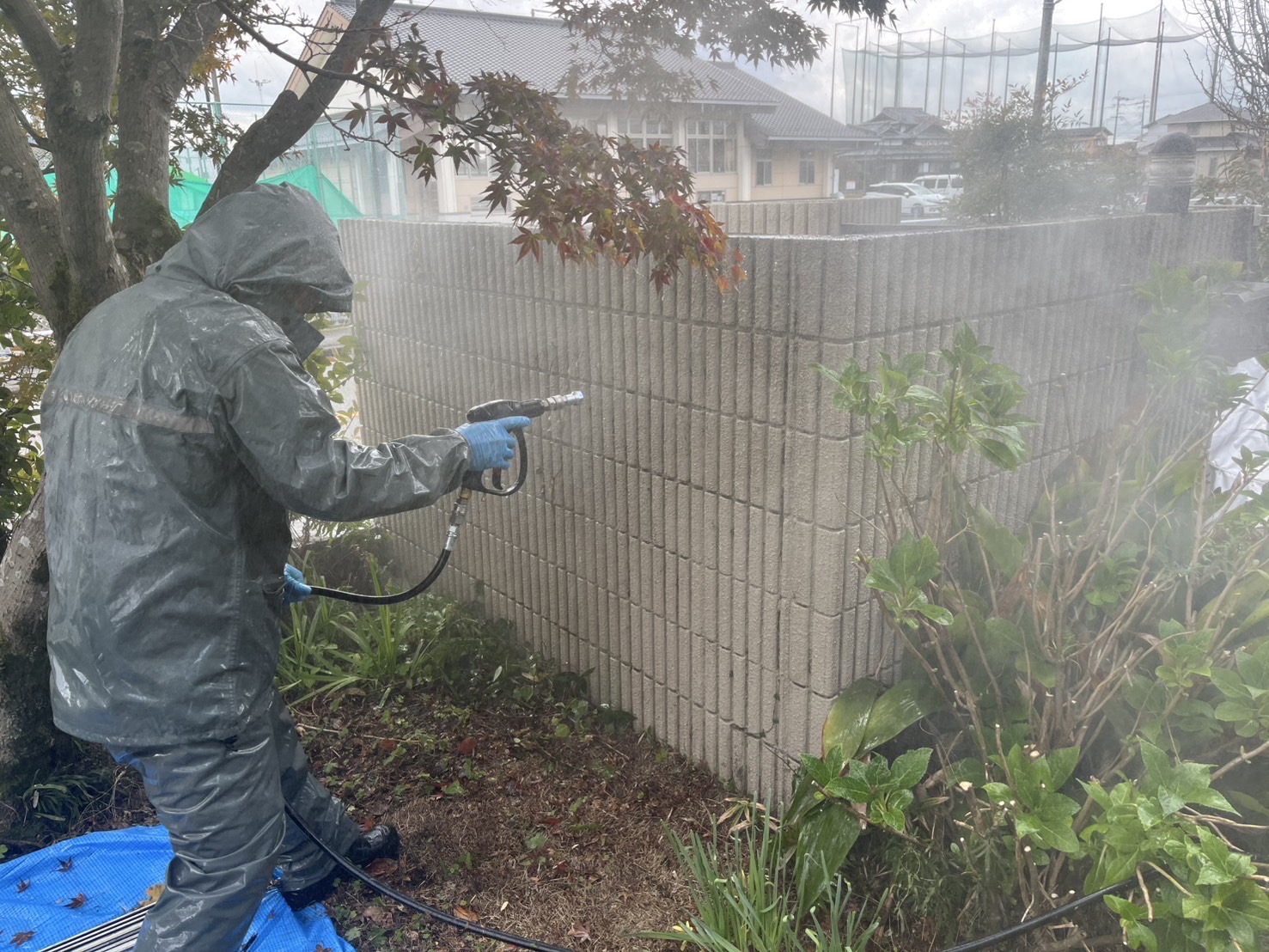 水戸市の住宅で塀の汚れを高圧洗浄している様子